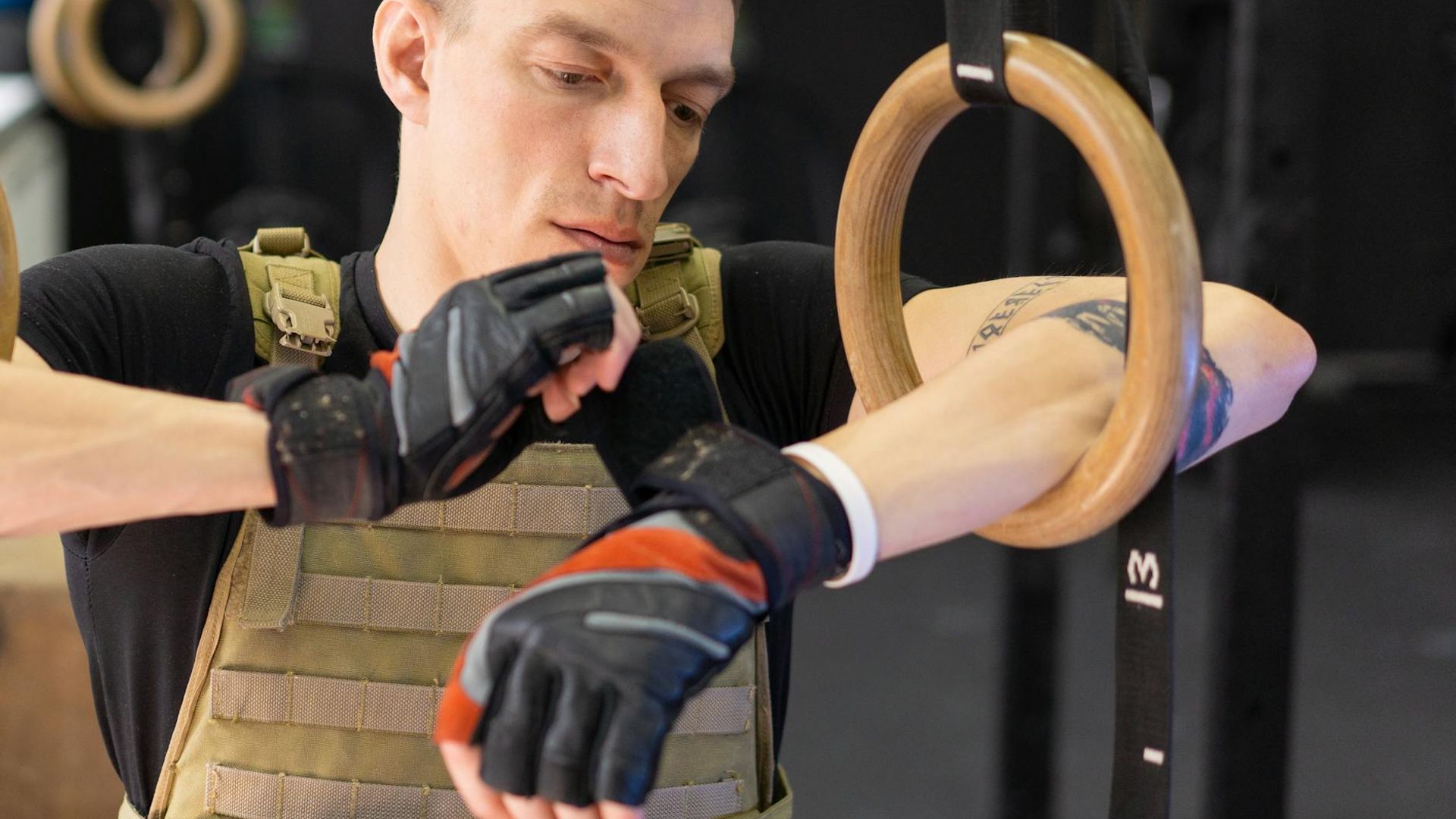 Focused man preparing for a strength workout in a minimalist gym.