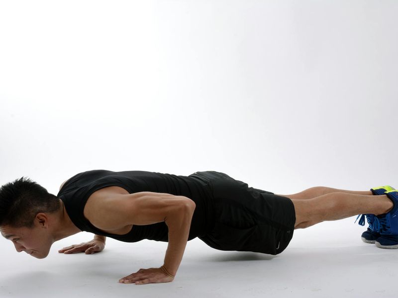 Man performing a controlled push-up with perfect form.