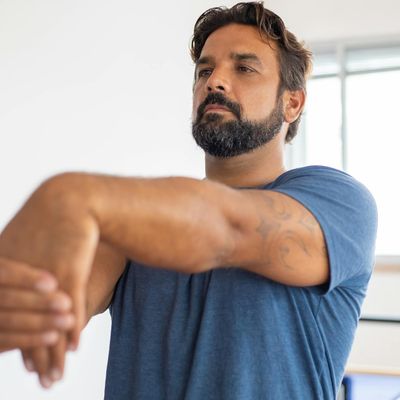 Man stretching his arms in a calm environment.